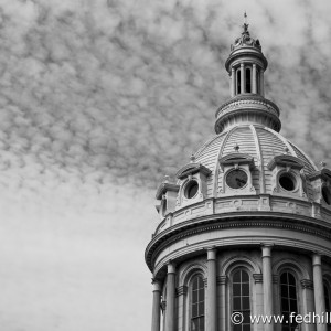 Black and white fine art photo of City Hall Dome in Baltimore, Maryland. Puffy clouds.