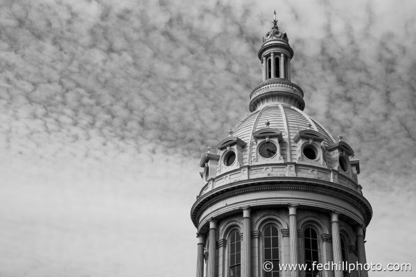 Black and white fine art photo of City Hall Dome in Baltimore, Maryland. Puffy clouds.