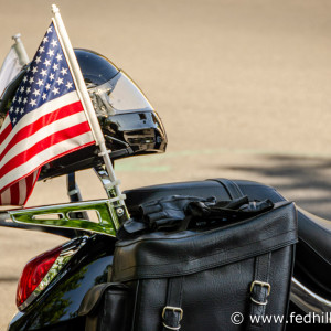 Fine art photograph of a motorcycle seat, motorcycle helmet, and United States flag attached to the seat.