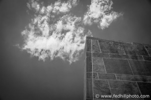 Black and white fine art photo of Oberlin College Hall auditorium wall and clouds and sky in Oberlin, Ohio.