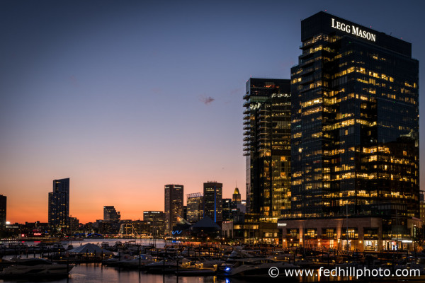 Fine art photograph of sunset over Harbor East and Inner Harbor in Baltimore City, Maryland. Water, marina, and buildings.