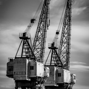 Black and white fine art photo of industrial ship cranes in Locust Point, Baltimore, Maryland.