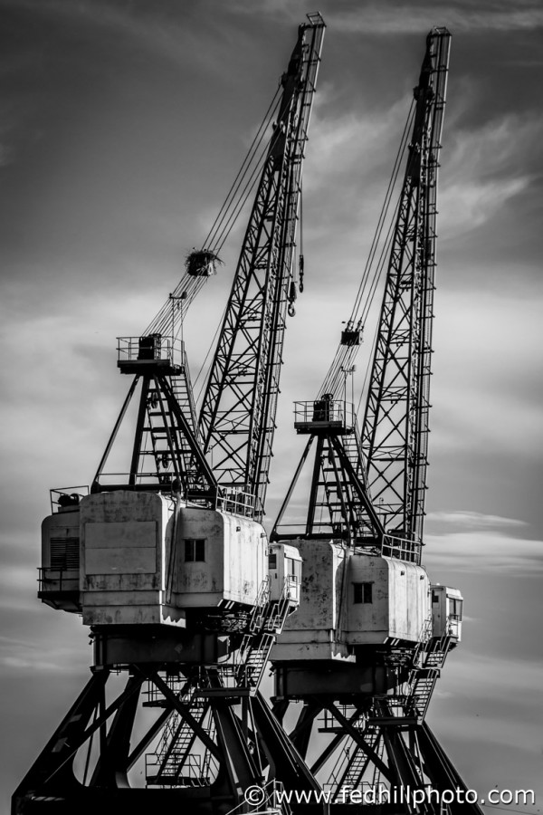 Black and white fine art photo of industrial ship cranes in Locust Point, Baltimore, Maryland.