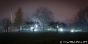 Fine art color photo of glow of lights in fog at night, Riverside Park, Baltimore, Maryland.