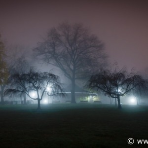 Fine art color photo of glow of lights in fog at night, Riverside Park, Baltimore, Maryland.