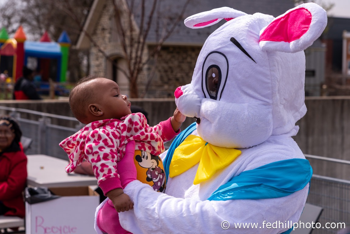 Community non profit holiday photo of a child being held by the easter bunny.