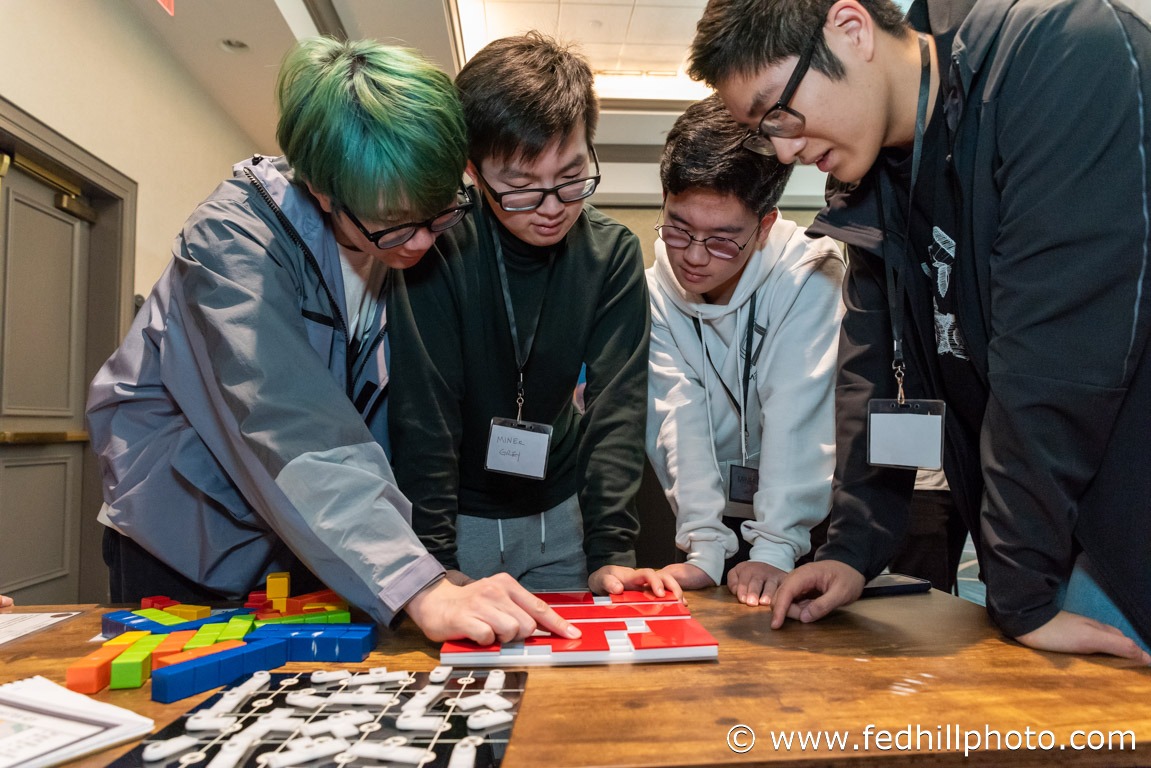 Corporate event photo of a group of people solving a puzzle.