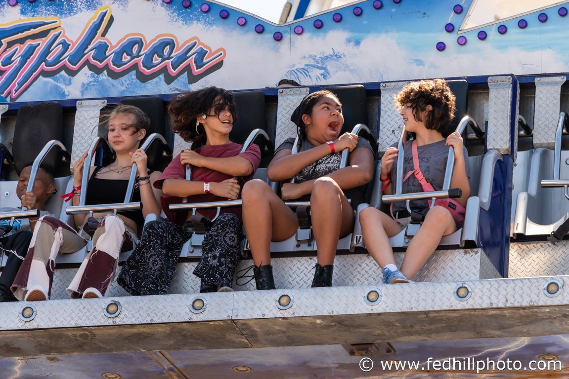 Community event photo of people riding a carnival ride.